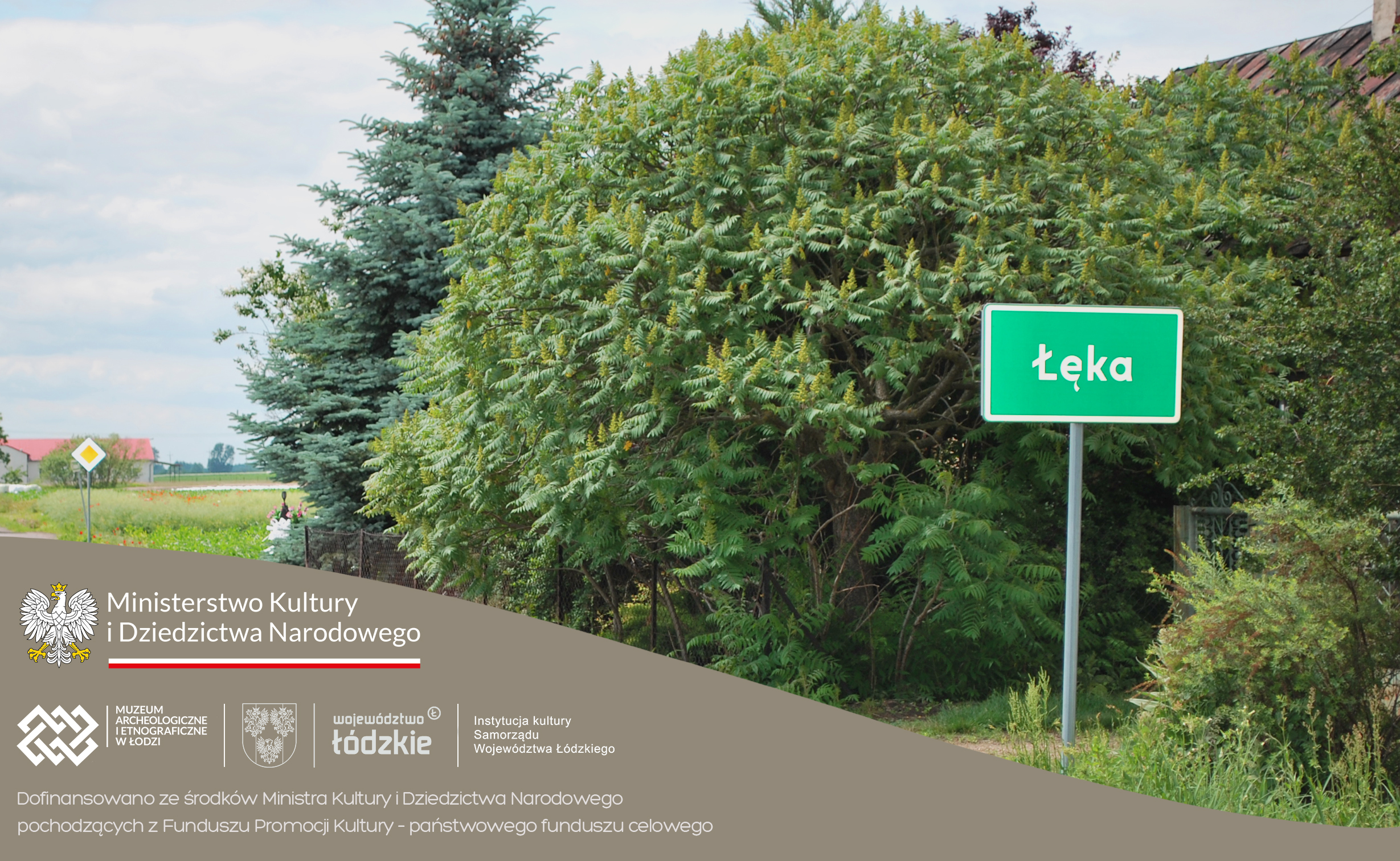 grafika pzedstawiająca wjazd do wsi Łęka, na pierwszym planie tabliczka z napisem miejscowości, w tle zielone drzewa